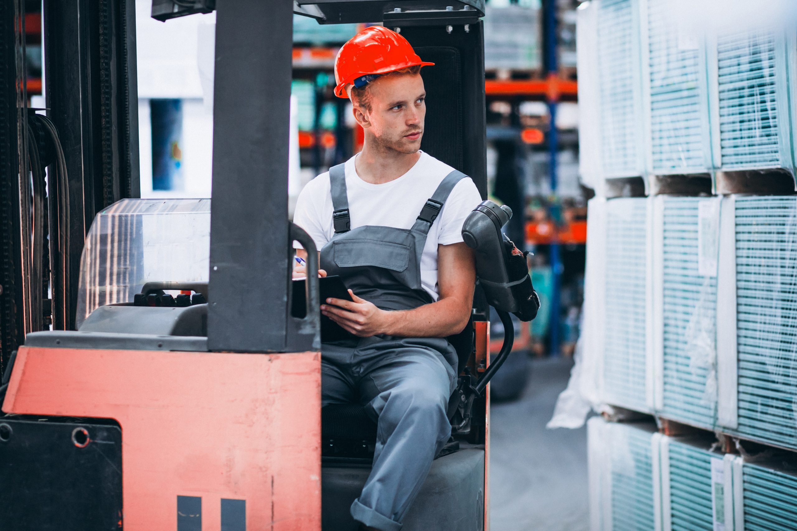 young-man-working-warehouse-with-boxes young-man-working-warehouse-with-boxes
